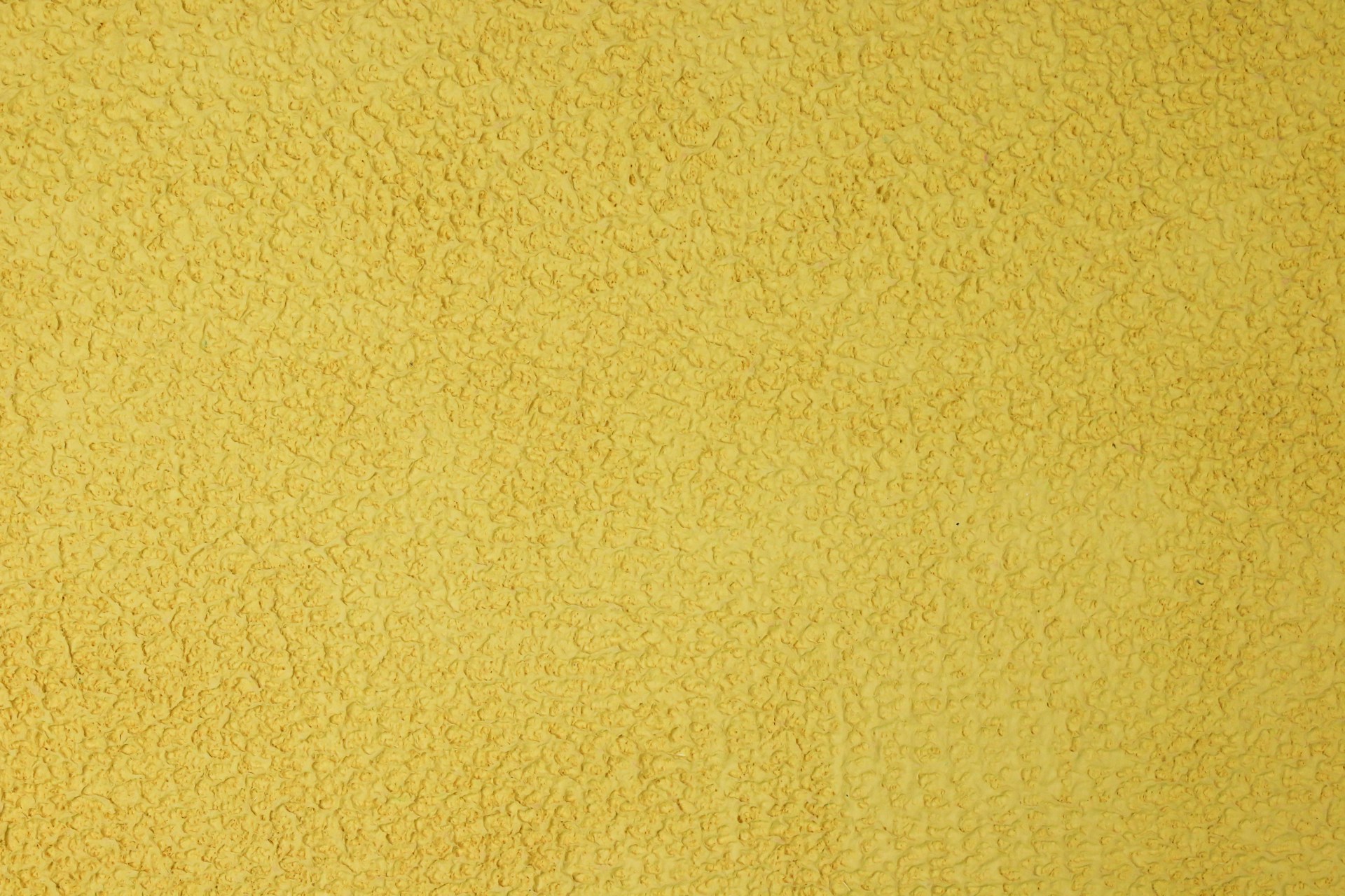 yellow wall paint in close up photography