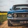 blue chevrolet camaro on road during daytime