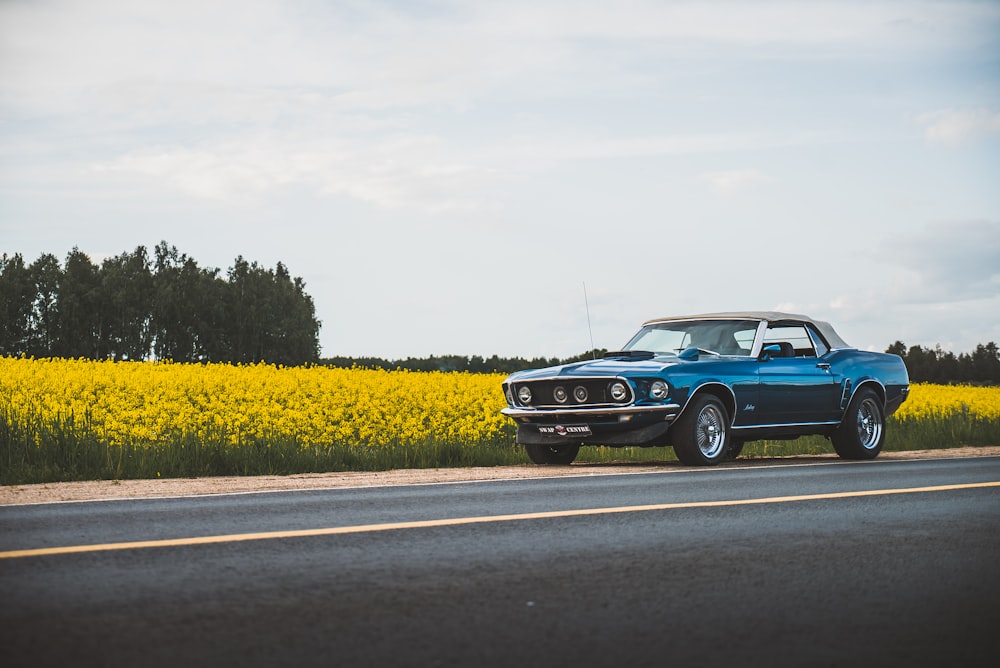 blue classic car on road during daytime