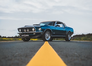 blue chevrolet camaro on road during daytime