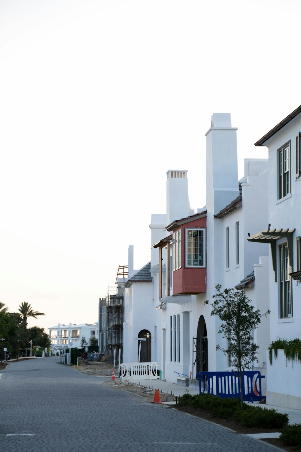 cars parked beside white concrete building during daytime