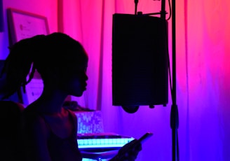 woman in black tank top standing near black microphone stand