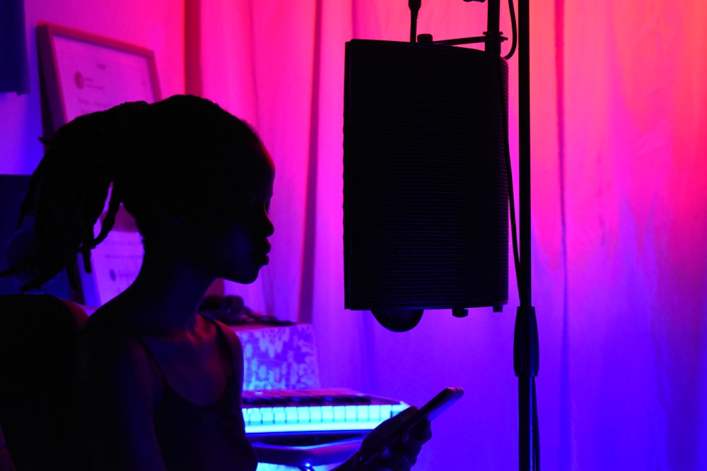 woman in black tank top standing near black microphone stand