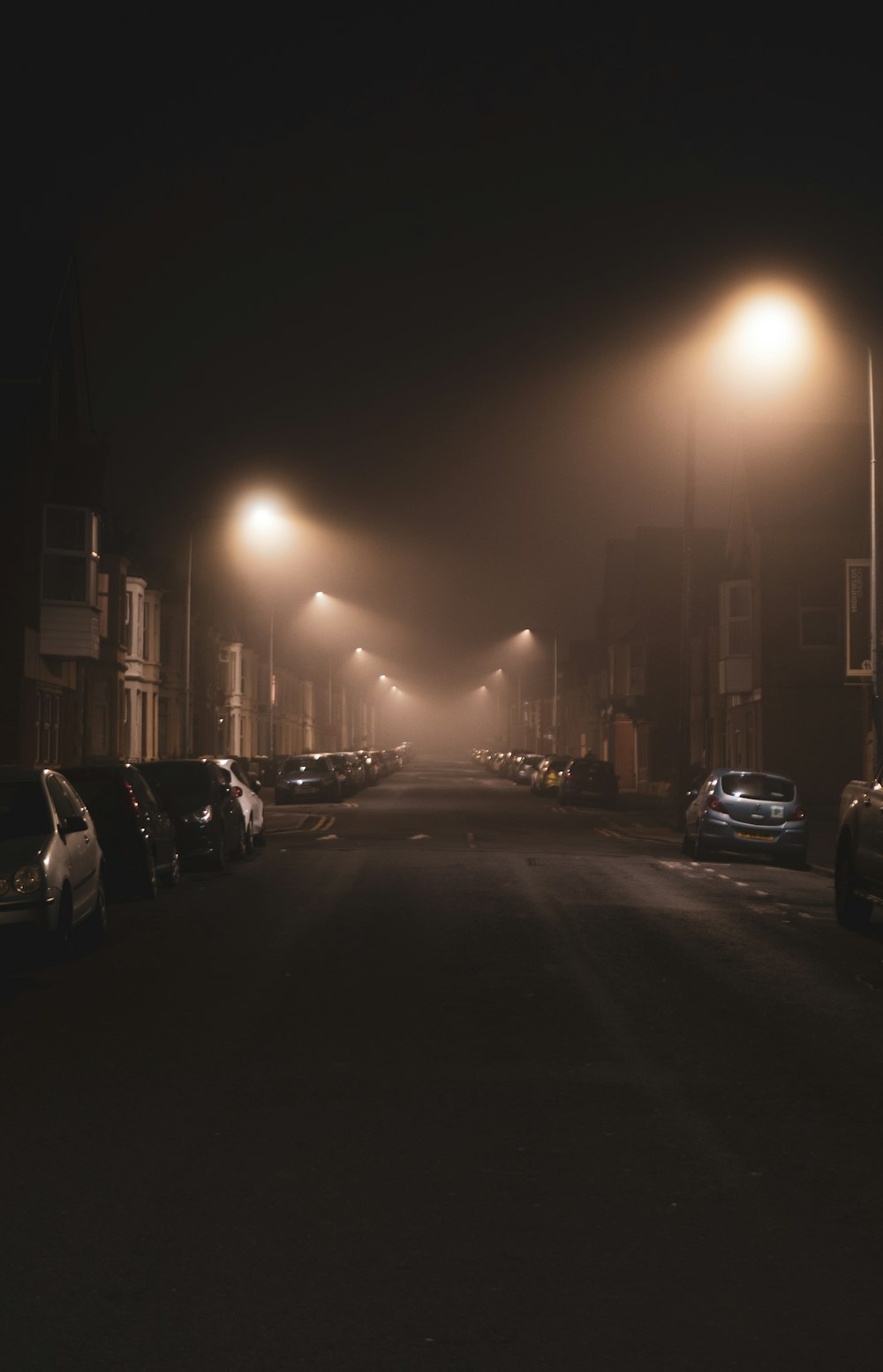 cars parked on side of the road during night time