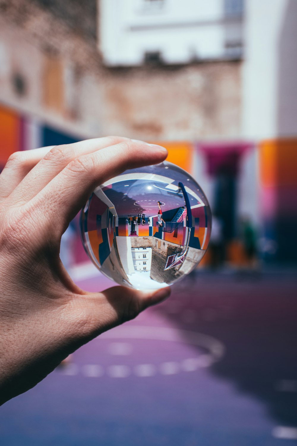 person holding clear glass ball