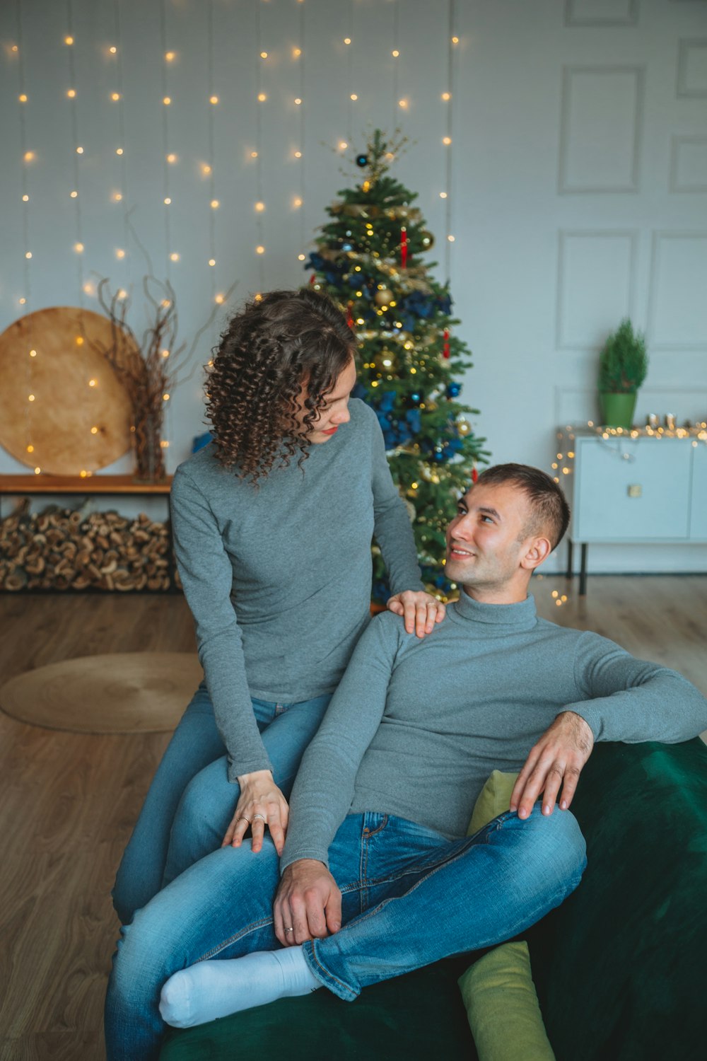 woman in gray sweater sitting on brown sofa chair