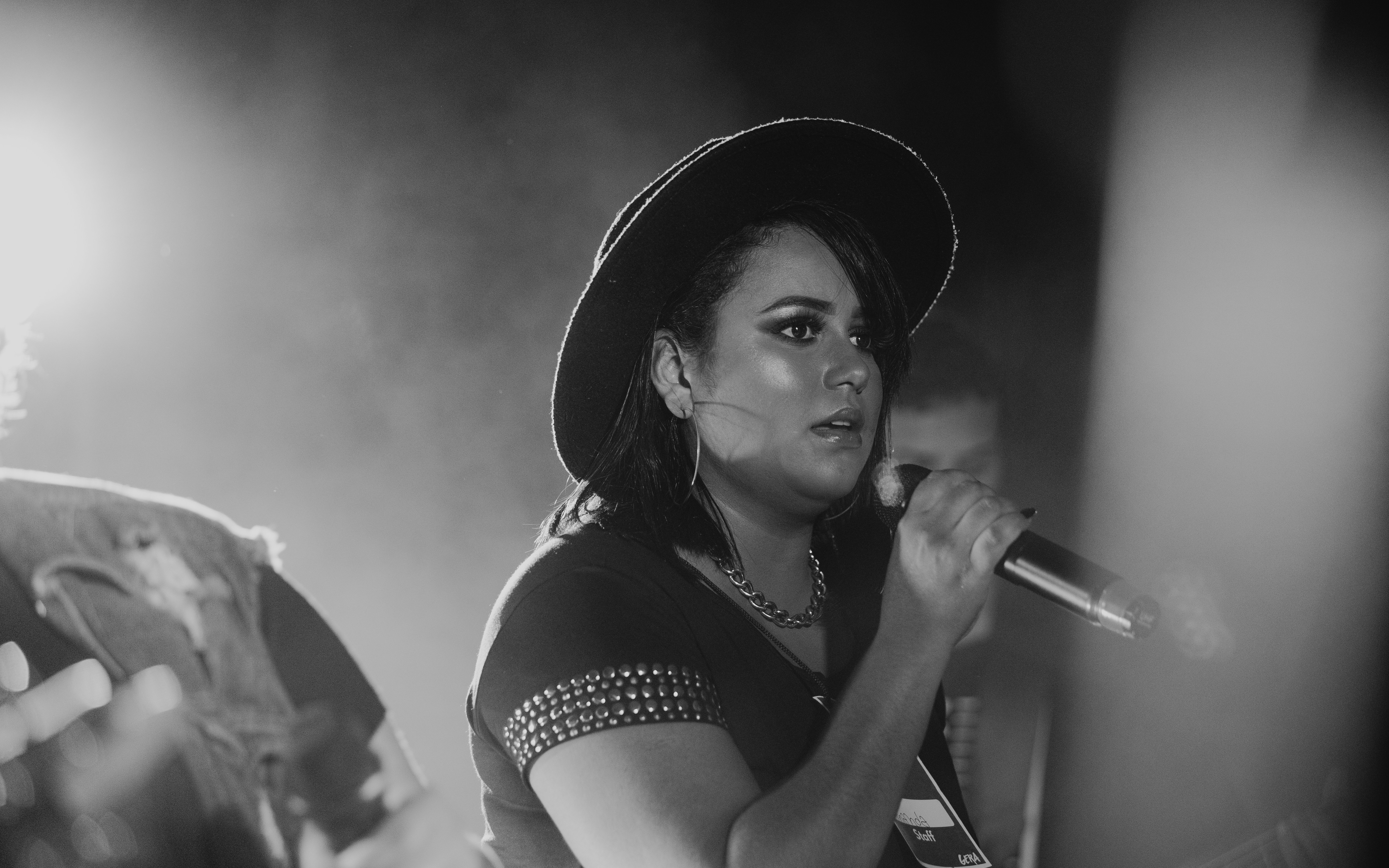 grayscale photo of woman singing
