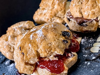 Close-up of golden chocolate chip cranberry scones with a dusting of powdered sugar