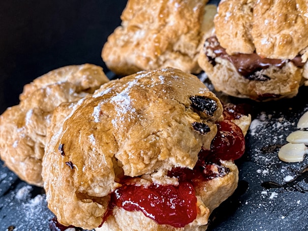 A cozy shot of freshly baked dairy-free scones served with jam and tea.