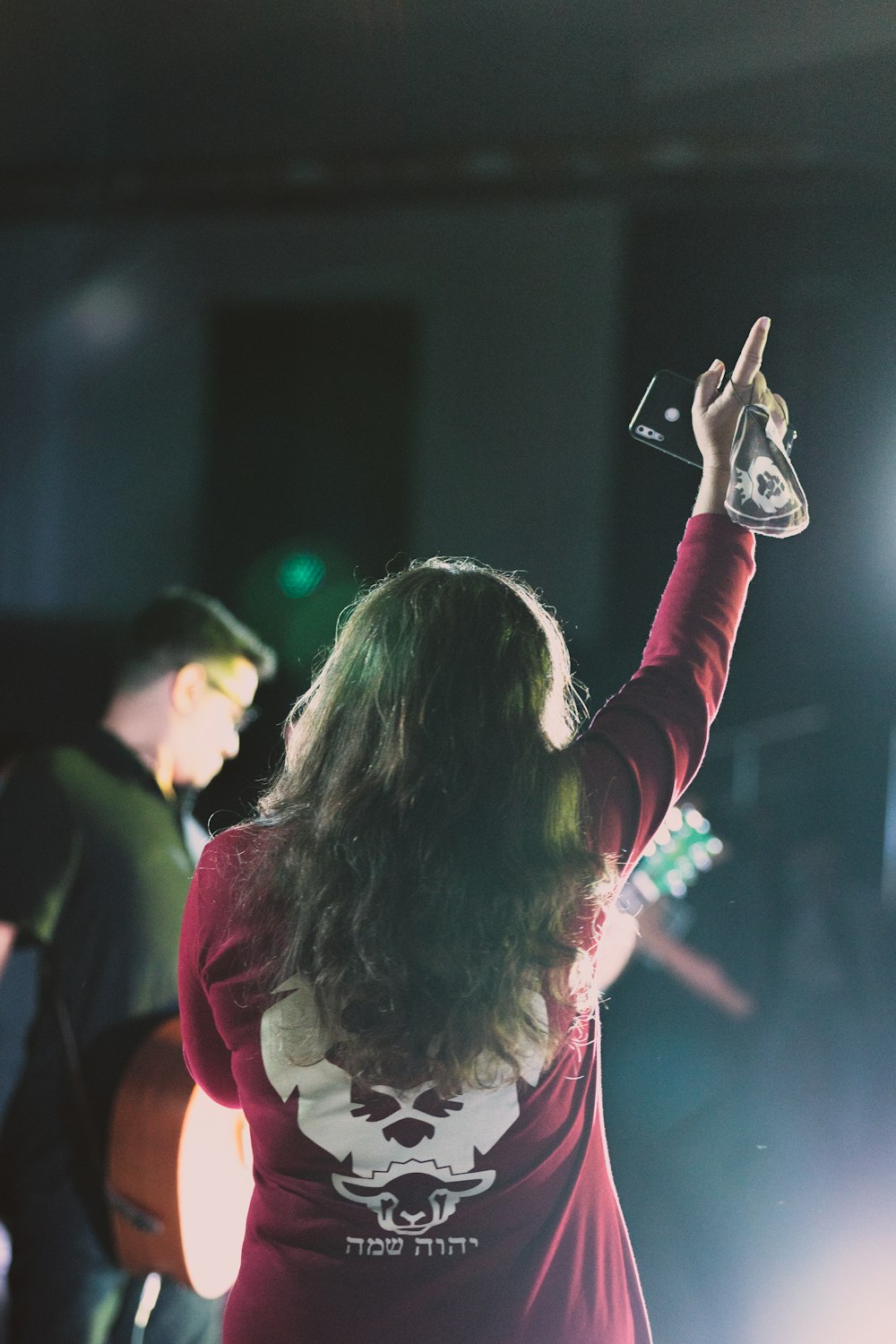 woman in red long sleeve shirt holding smartphone