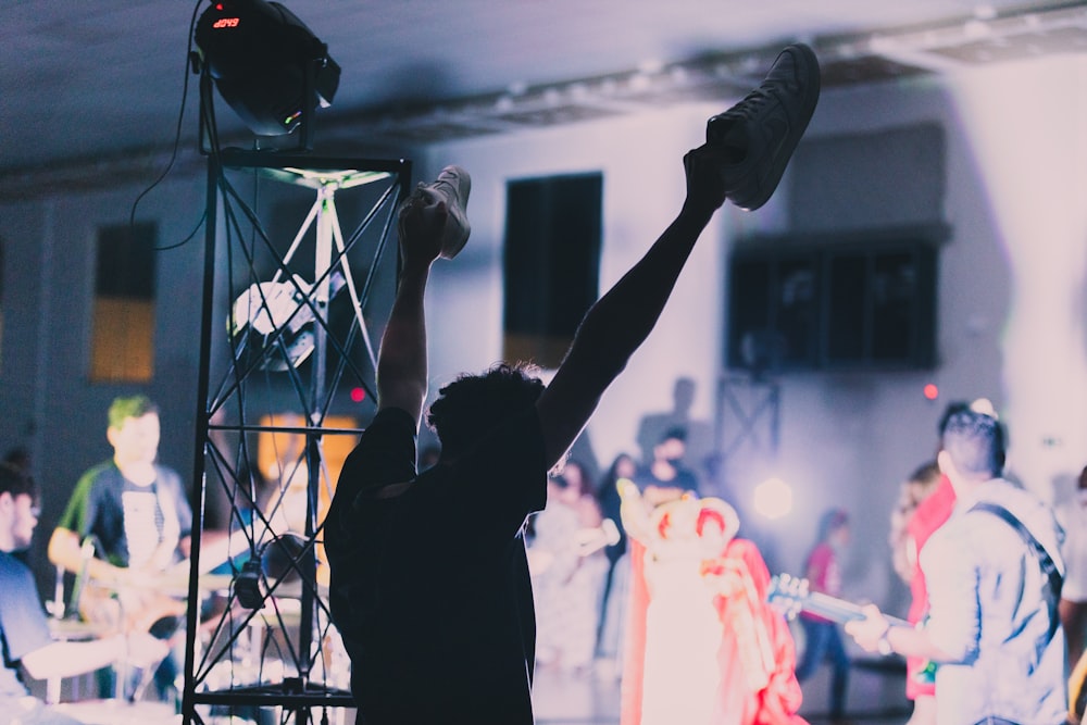 silhouette of man raising his hands