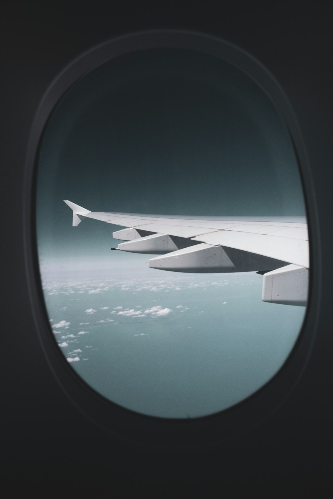 airplane window view of white clouds during daytime