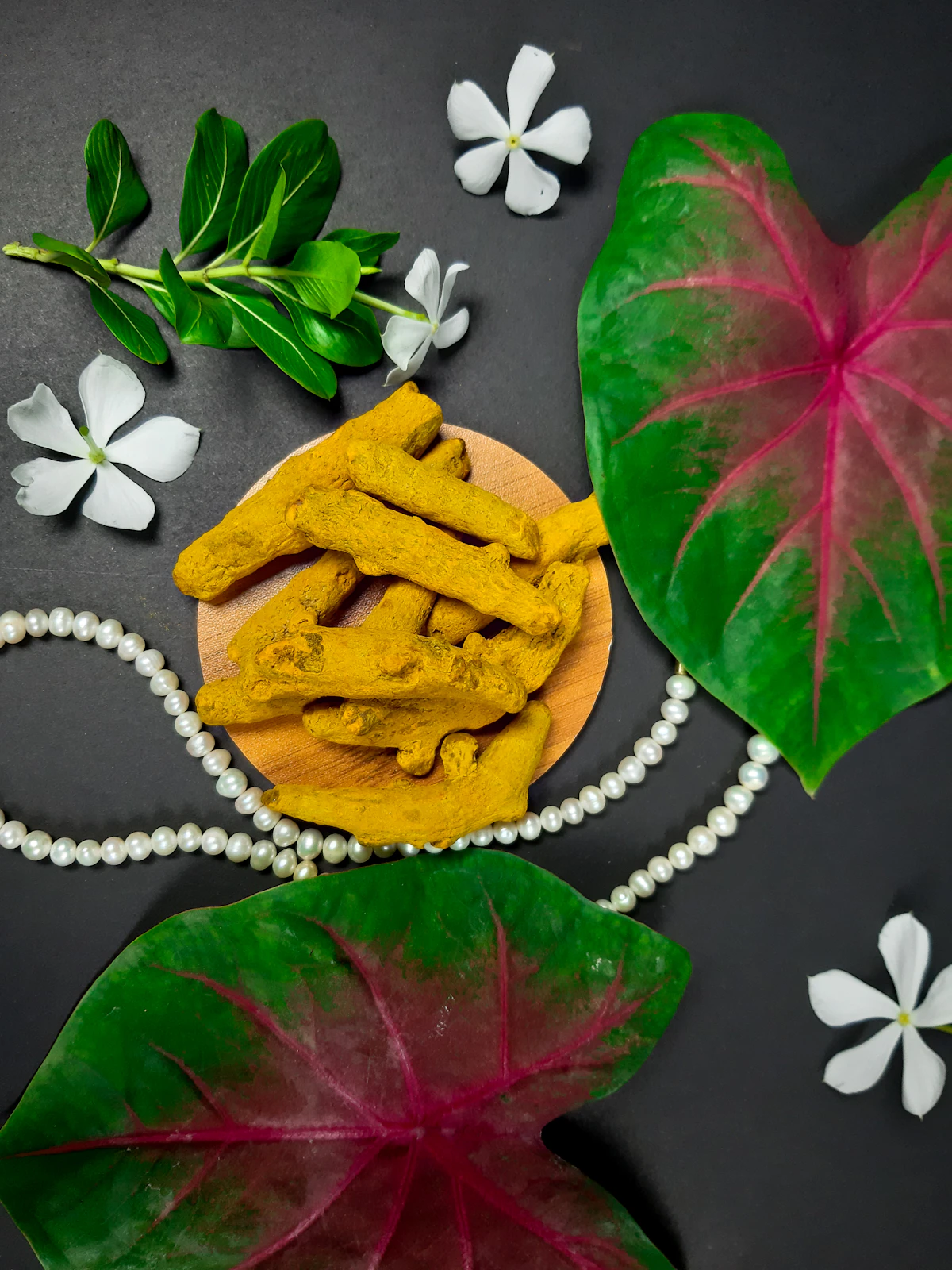 Dried turmeric rhizomes, leaves and botanicals prepared for formulation