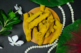 Close-up of vibrant turmeric roots growing in hydroponic trays bathed in warm sunlight.