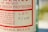 A close-up of a bottle label with text in red and black on a light background. The label includes wording related to Mexico and has a lot number handwritten as 16/7160.
