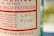 A close-up of a bottle label with text in red and black on a light background. The label includes wording related to Mexico and has a lot number handwritten as 16/7160.