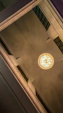 Close-up of decorative plasterboard ceiling details with warm spotlights in a cozy living room.