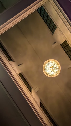Close-up of decorative plaster ceiling with warm lighting.