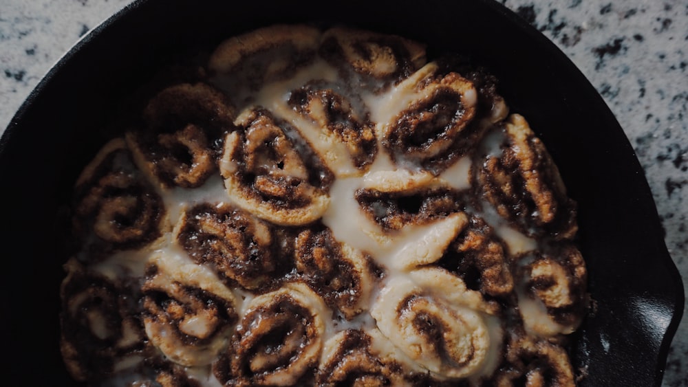 brown and white food on black cooking pan