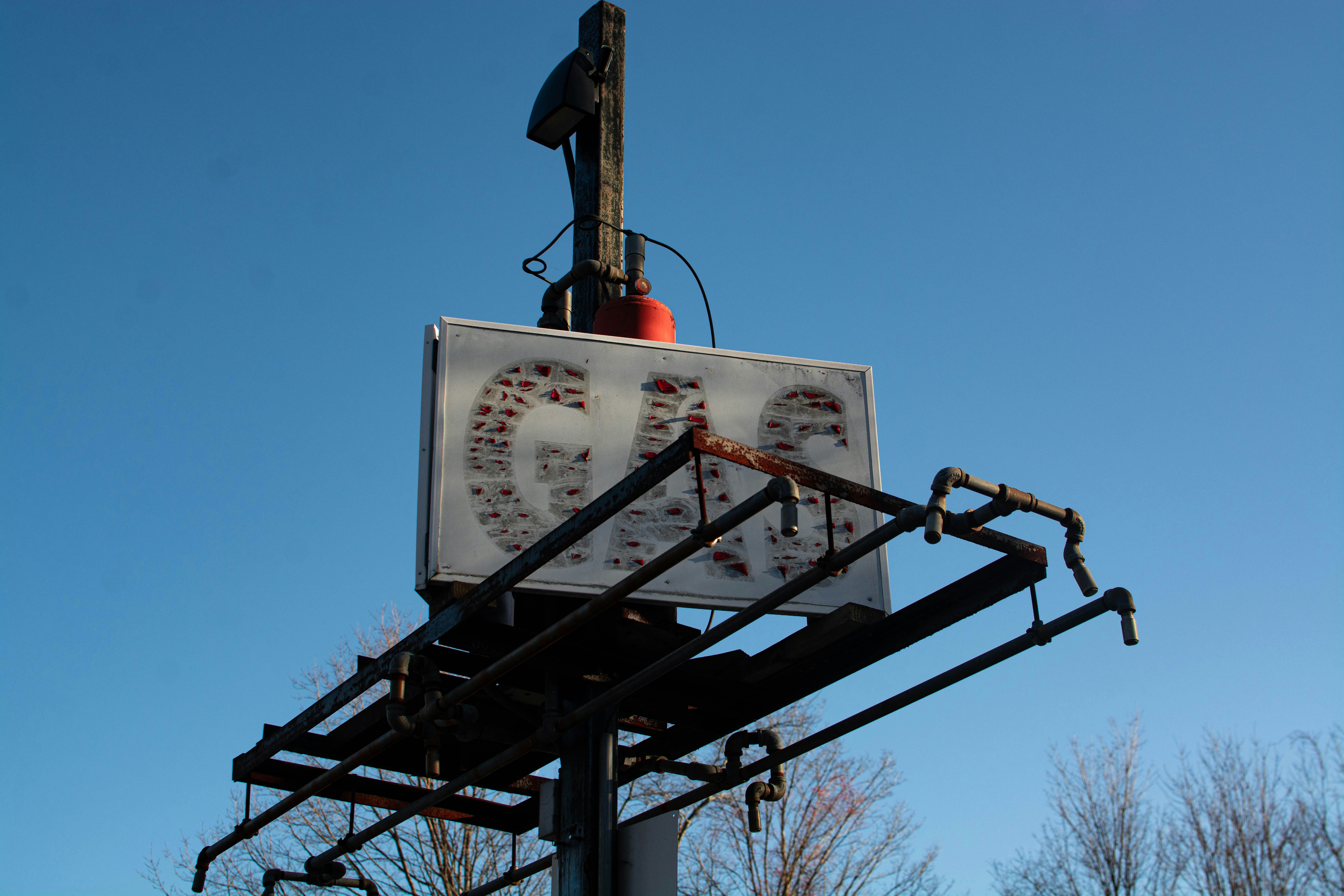 man in black jacket standing on black metal frame during daytime