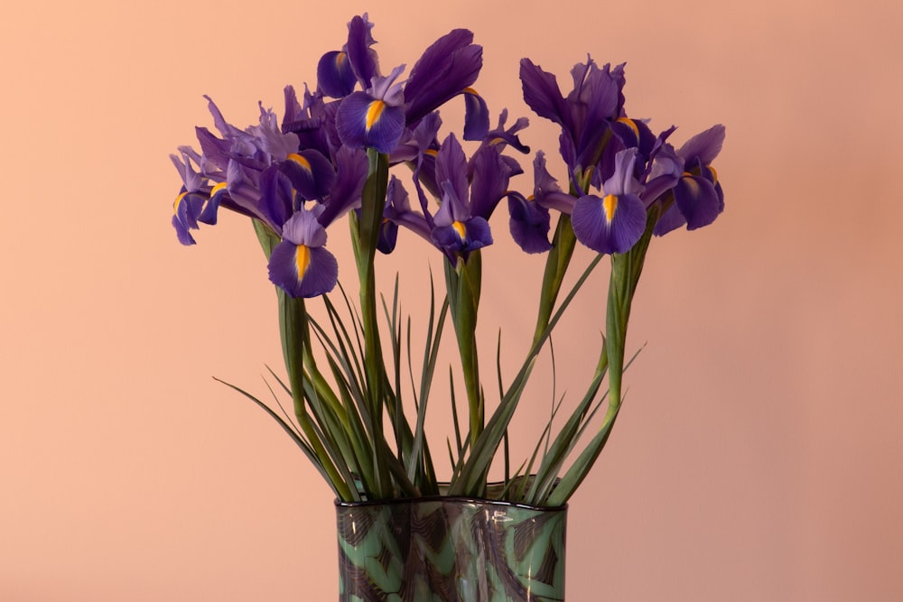 purple flowers in clear glass vase