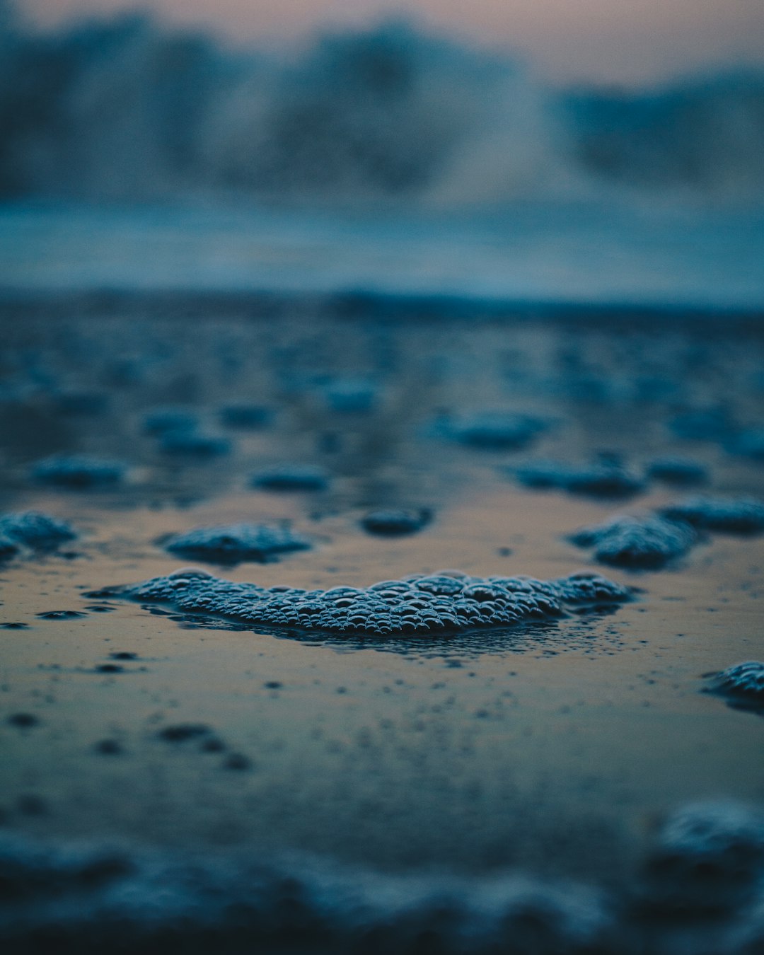 water droplets on brown sand