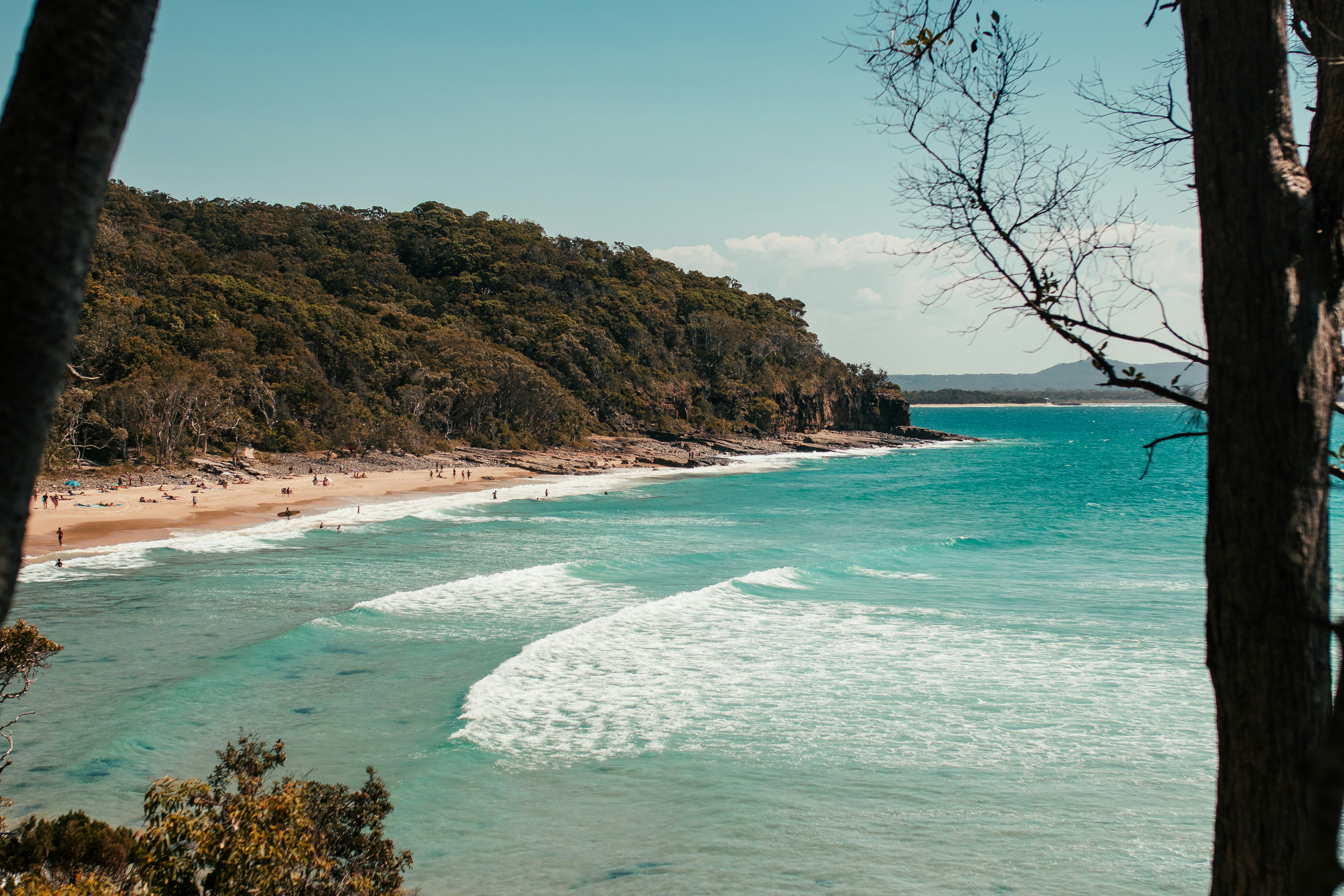 brown and green mountain beside beach in noosa