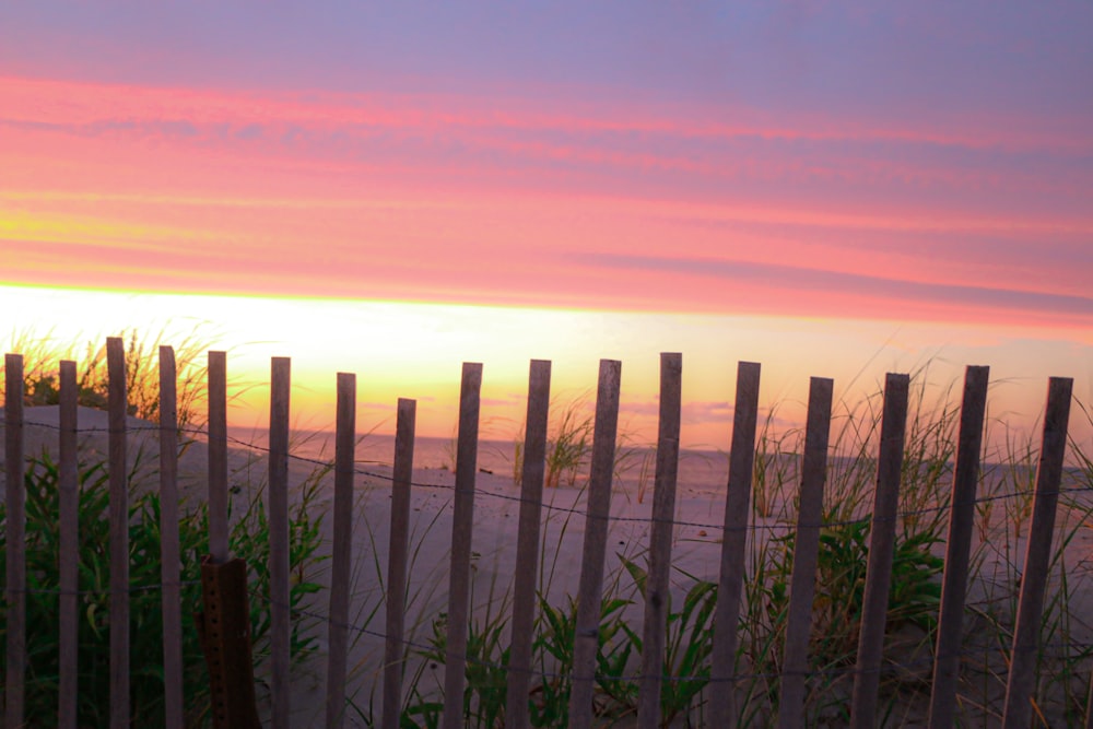 brown wooden fence during sunset