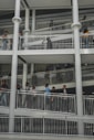people sitting on white metal railings