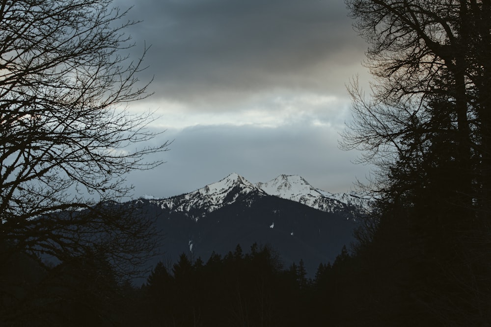 snow covered mountain under cloudy sky during daytime