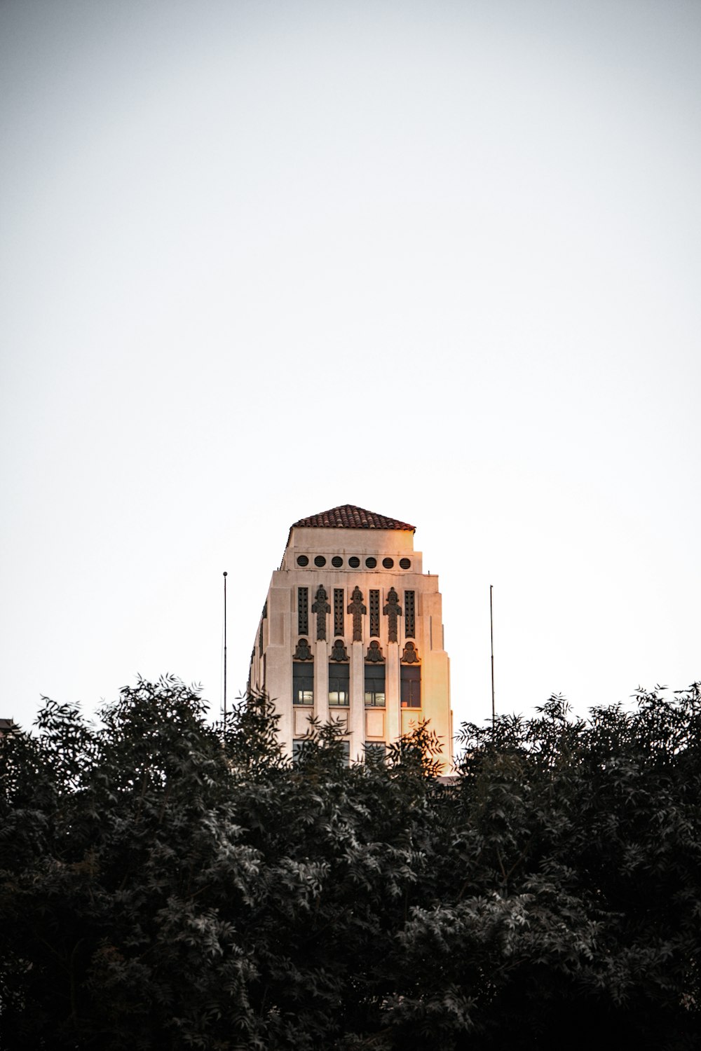 brown concrete building near green trees during daytime