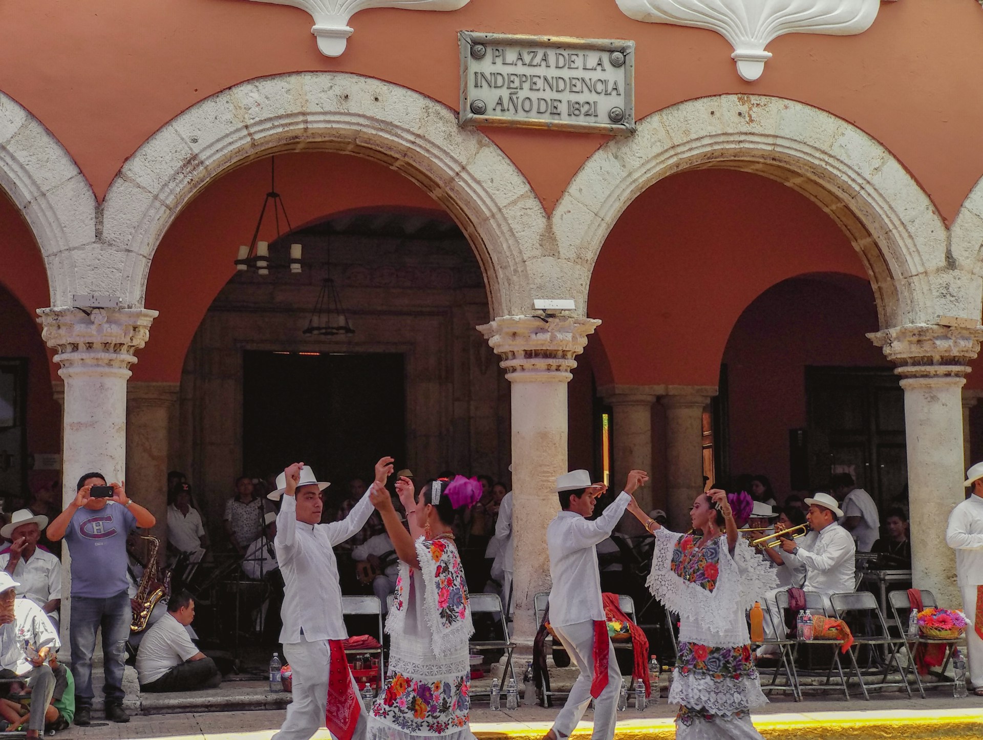 people standing near red concrete building during daytime