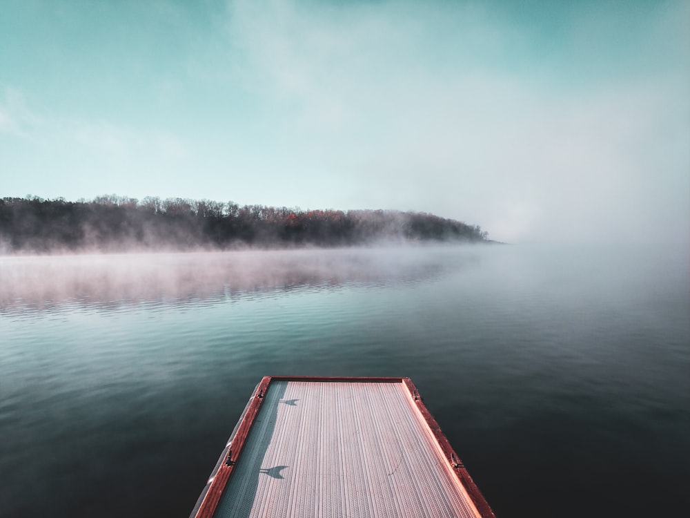 brown wooden dock over body of water