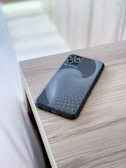 Modern smartphone case with a minimalist design displayed on a reflective black background.