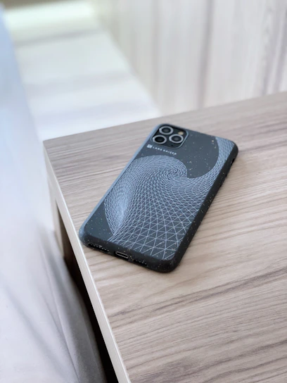 Sleek smartphone cases displayed on a modern wooden table with soft natural light highlighting vibrant colors.