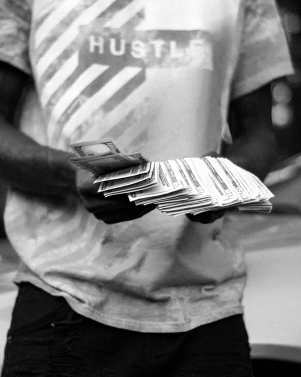 man in white and black crew neck t-shirt holding book