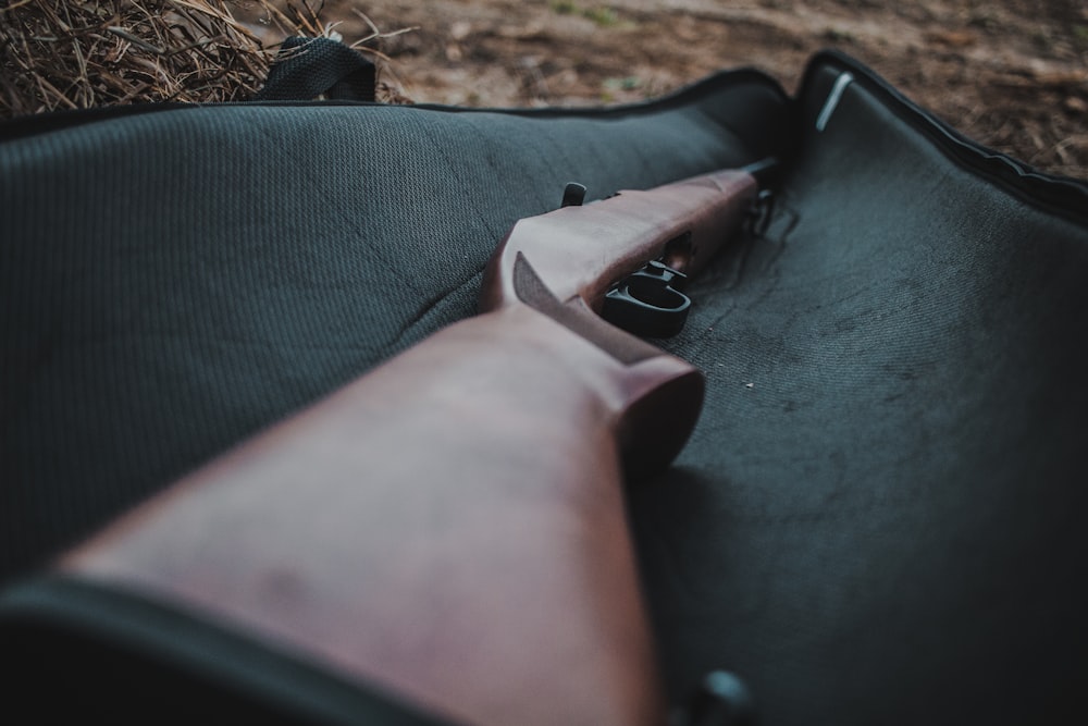 brown and black semi automatic pistol on black textile