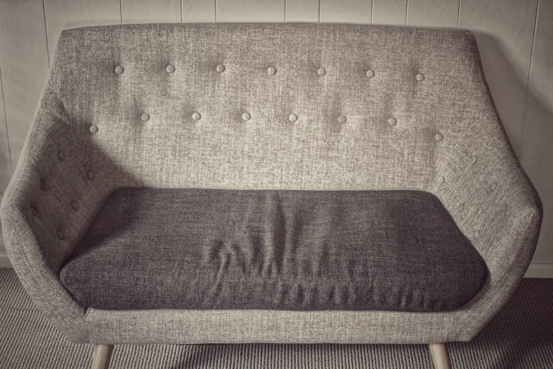 purple cushion on brown woven armchair