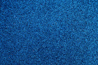 Blue-tinted nano powder particles clustered together with a soft glow.