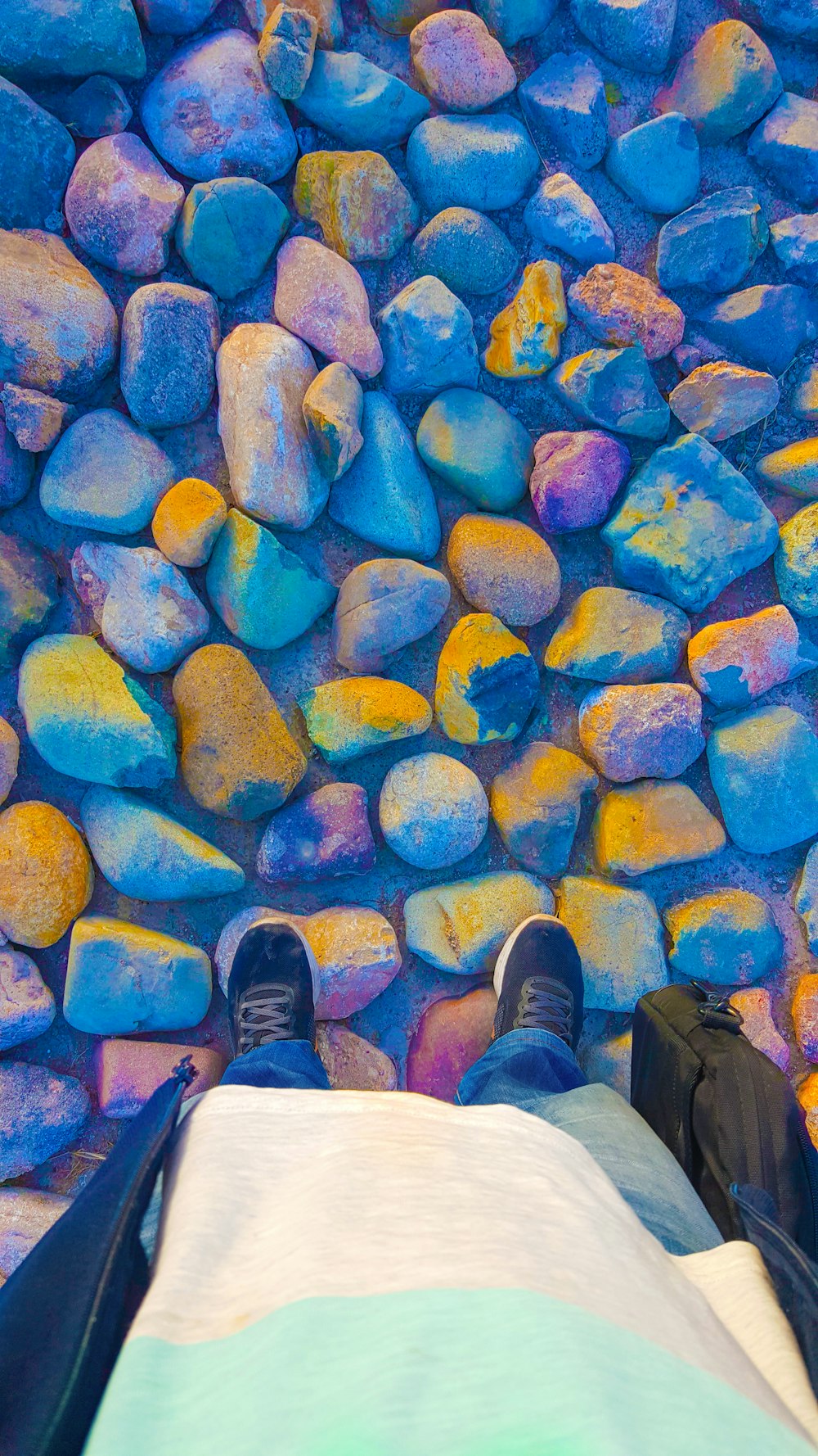 person in brown pants and black shoes standing on blue and yellow concrete floor