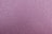 A textured surface composed of fine, closely-packed granules. The overall tone is a mix of pink and purple hues with subtle variations across the surface.