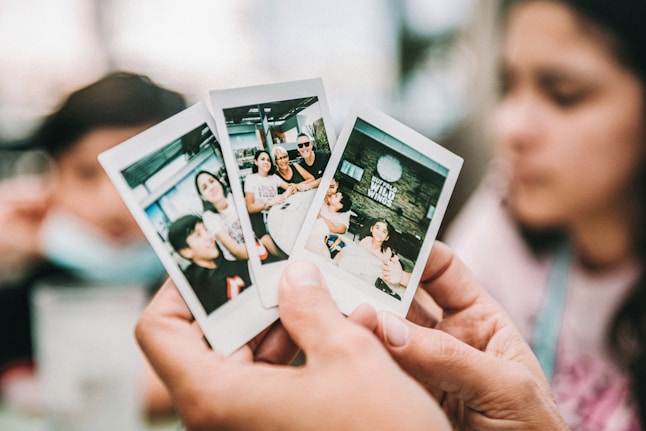 person holding 2 women photo