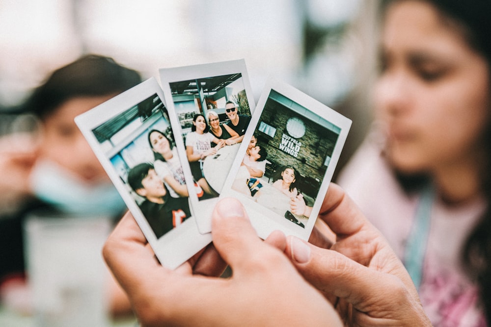 person holding 2 women photo