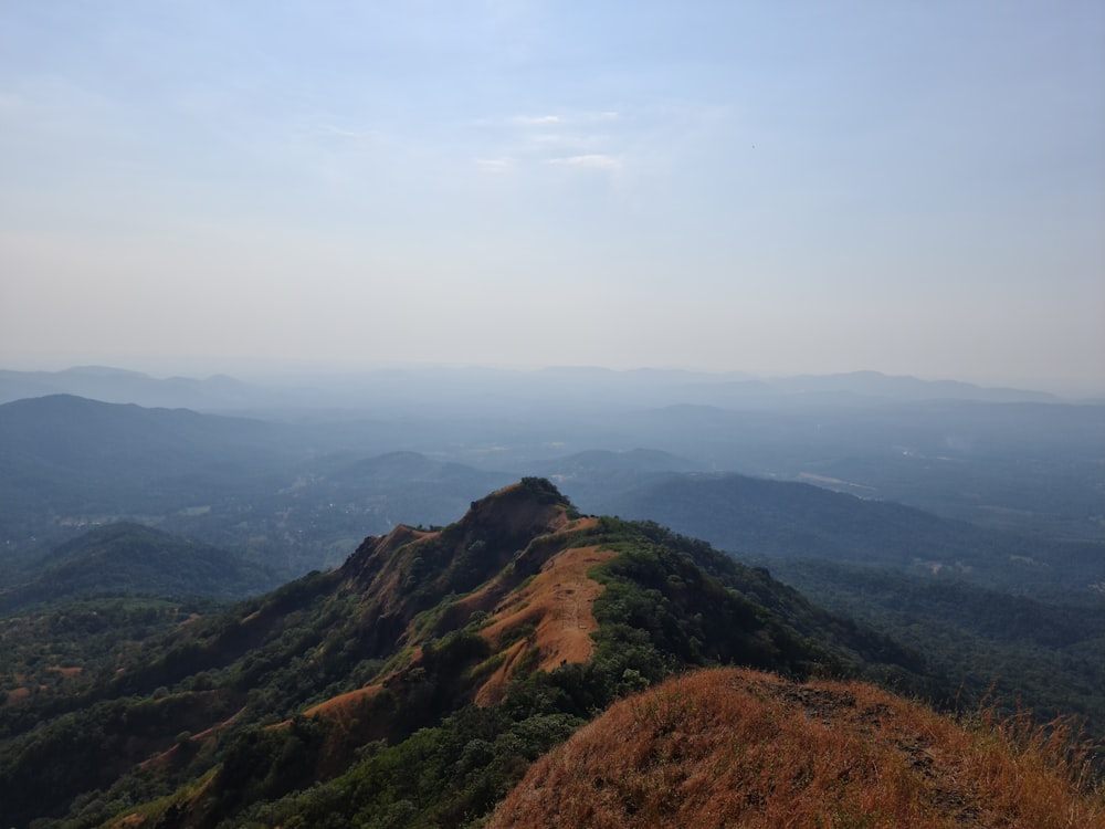 green and brown mountains under white clouds during daytime