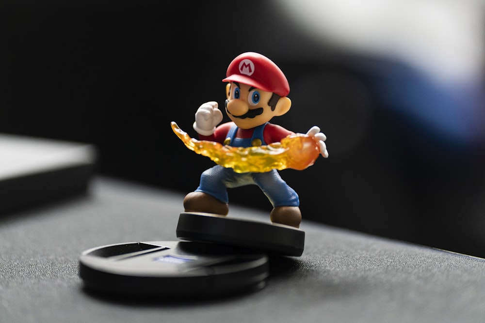 super mario figurine on black surface