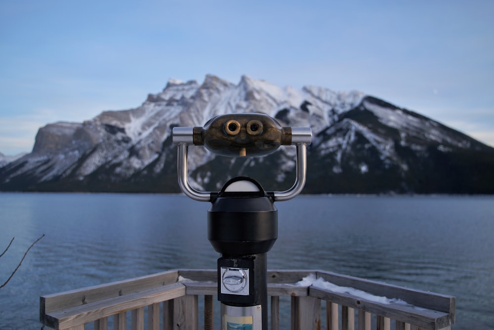 black and gray binoculars on brown wooden dock