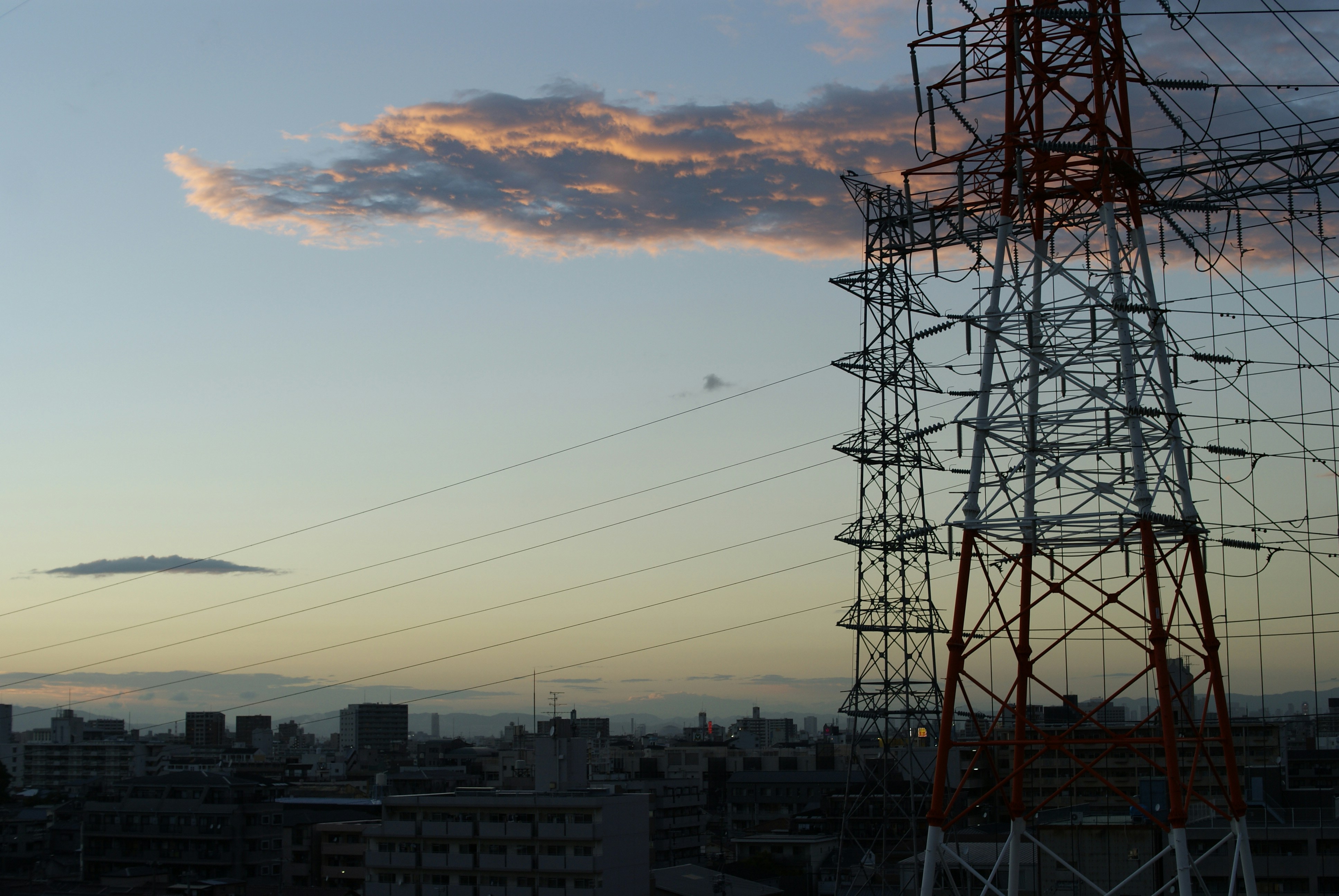 Power station cooling towers at dusk, industrial landscape, dramatic sky, electricity infrastructure