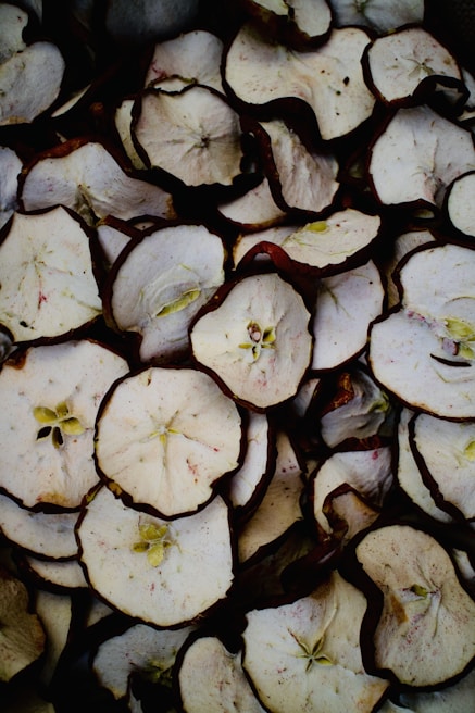Freshly picked organic apples being sliced for dehydration in a bright kitchen