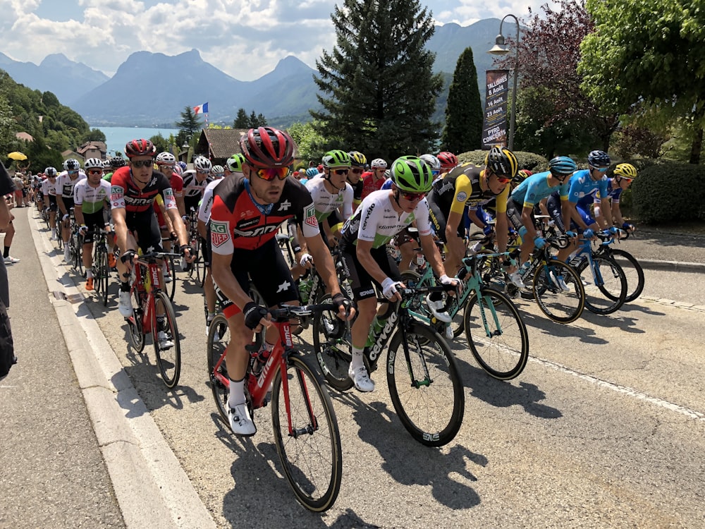 people riding bicycle on road during daytime