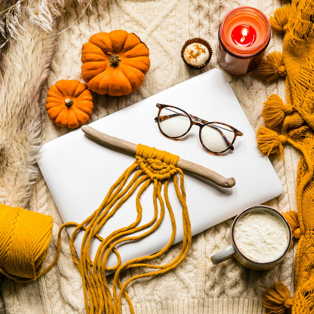 yellow and white rope beside brown rope and silver round analog watch